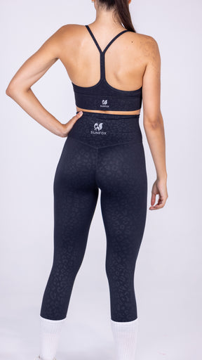 lady wearing black leggings ad crop top