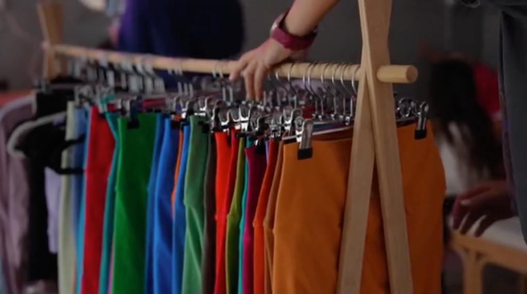 clothes rack containing leggings in all different colours